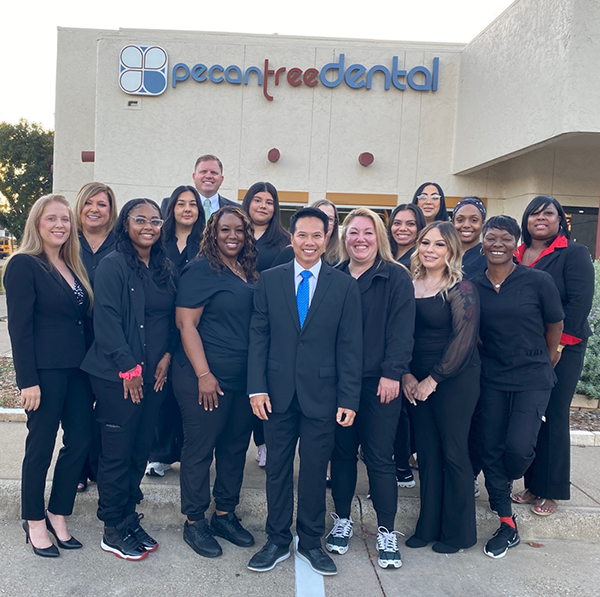 Grand Prairie dentist and team gathered outside smiling