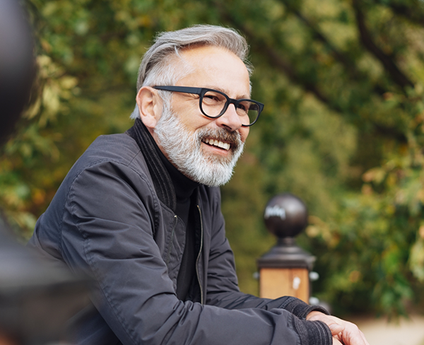 Senior man with glasses smiling