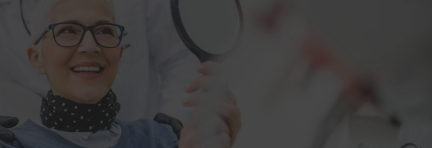 Female dental patient with glasses smiling