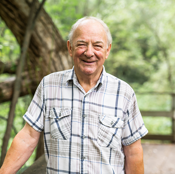 Senior man walking outside and smiling