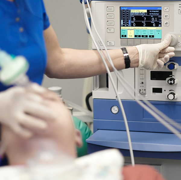 Dentist turning on machine for sedation dentistry in Grand Prairie