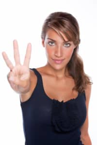 Beautiful Woman Holding Up 3 Fingers